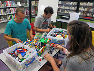 Photo of patrons playing with Lego in the library