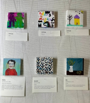 Cedar Rapids Public Library Tiny Art Show Close-up of six tiny square painted canvasses with title and author cards